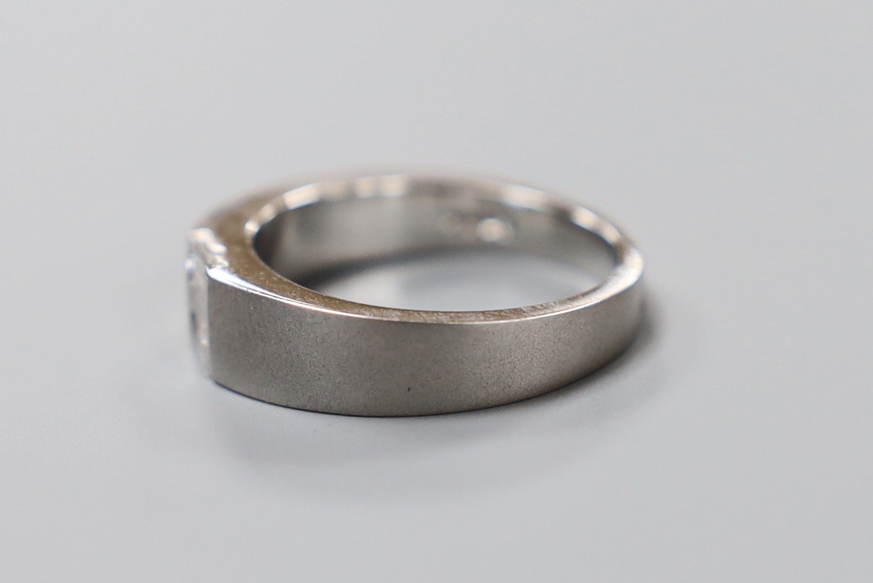 A modern sandblasted platinum and the stone baguette cut diamond set ring, size P/Q, gross weight 10.7 grams